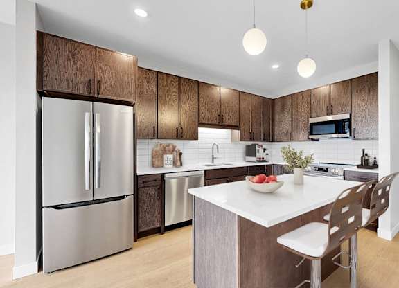 A modern kitchen with a wooden backsplash and stainless steel appliances.