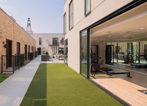 A modern building with a green lawn in front.