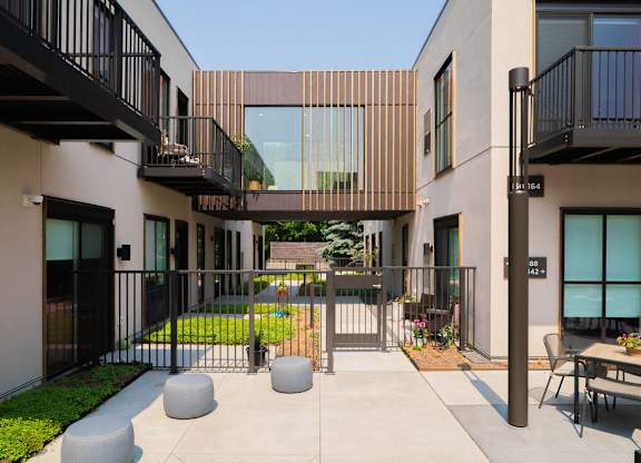 A modern building with a black metal fence and a glass door.