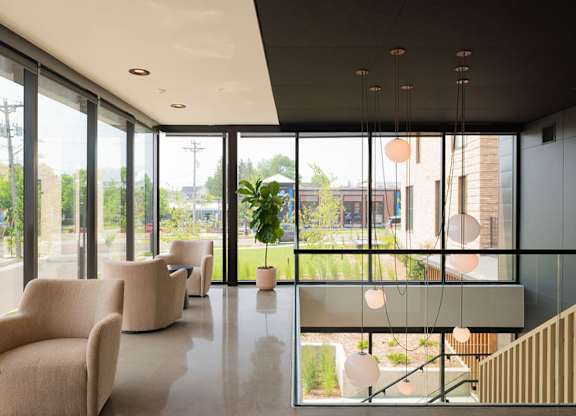 A modern interior space with a view of the outdoors through large windows.