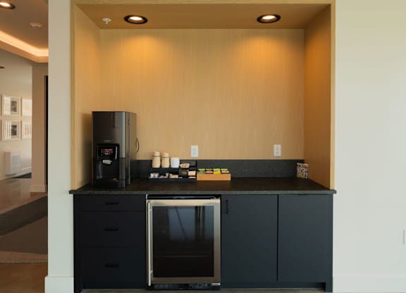A kitchen with a black countertop and a black oven.