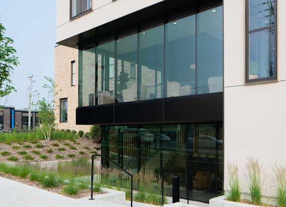 A modern building with large windows and a glass door.