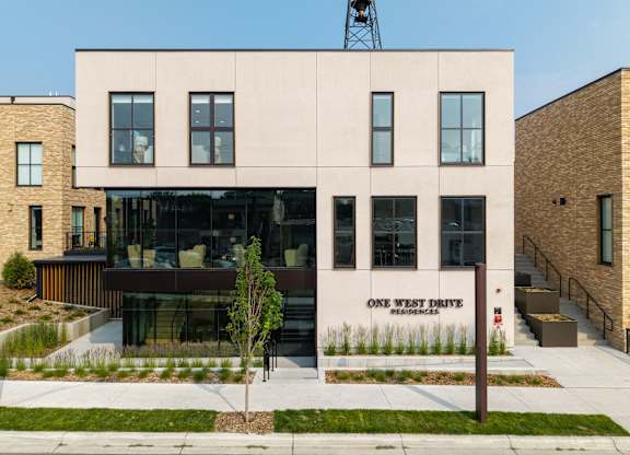 A modern building with the words "One West Drive" on the side.