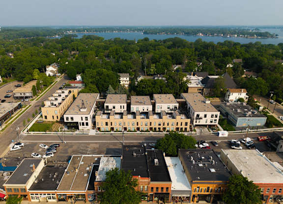A view of a parking lot and buildings from an aerial perspective.