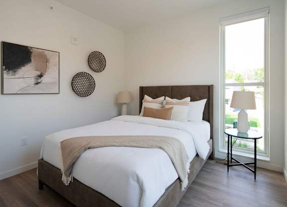 A bedroom with a large bed and a window.