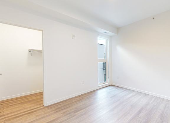 A room with wooden flooring and white walls at One West Drive Apartments, Excelsior, MN 55331