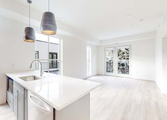A modern kitchen with a white countertop at One West Drive Apartments, Minnesota, 55331