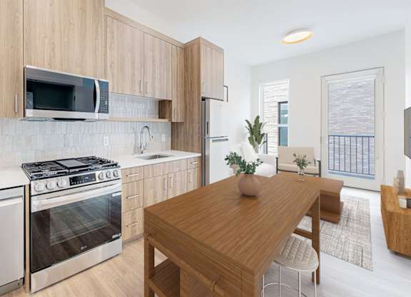 A modern kitchen with wooden cabinets and stainless steel appliances.