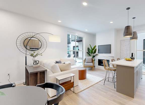 A modern living room with a grey table and a white sofa.