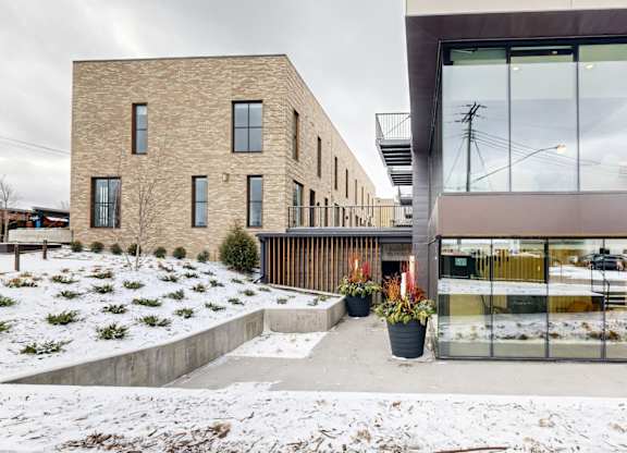 A modern building with a glass facade is shown.