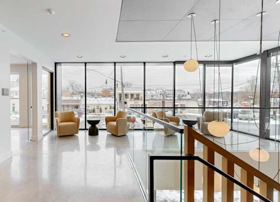 A spacious interior with a glass railing and a view of the outdoors.