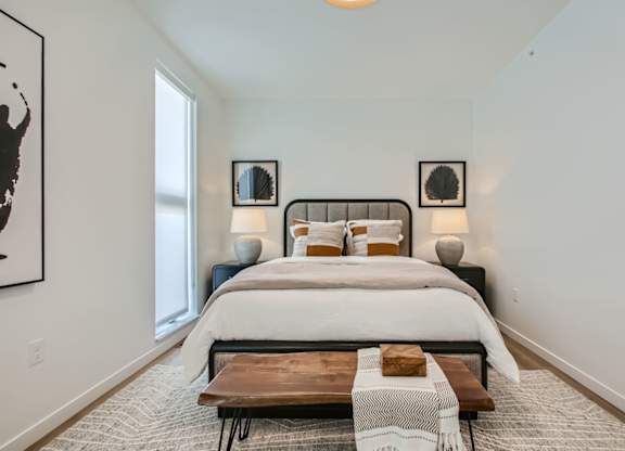 Bedroom with a bed and a window at One West Drive Apartments, Excelsior, MN