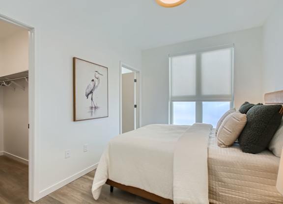 a bedroom with a bed and a closet at One West Drive Apartments, Excelsior, MN 55331