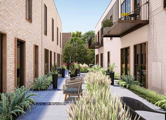 a courtyard with benches and plants outside of a building at One West Drive Apartments, Excelsior