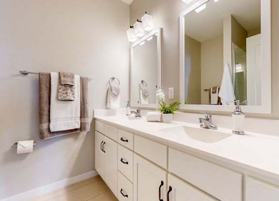 A bathroom with a white counter and a large mirror.