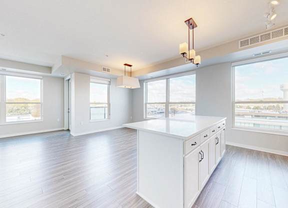 A spacious kitchen with white cabinets and a large island.