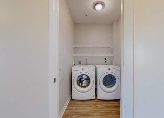 A laundry room with two washing machines.