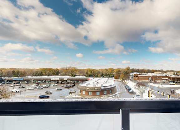 A parking lot with a circular building in the middle.