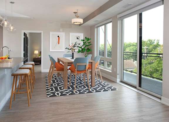 A dining room with a table set for six.