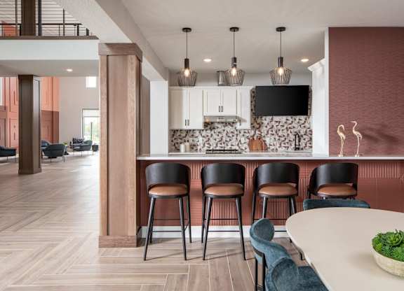 A modern kitchen with a bar area and seating.at The Edison at Maple Grove, Maple Grove, MN 55311