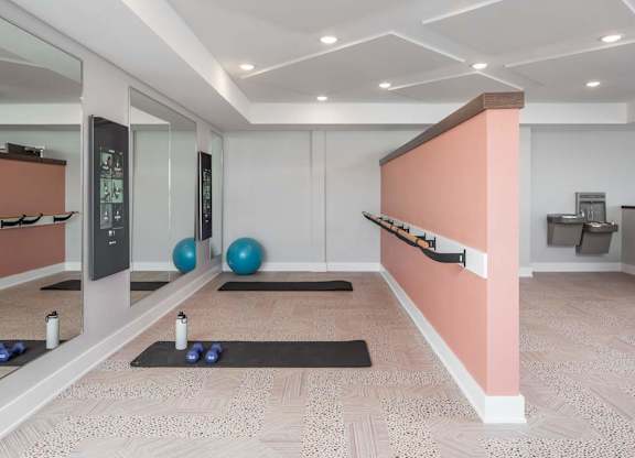A room with a mirror, exercise balls, and yoga mats.at The Edison at Maple Grove, Maple Grove, 55311