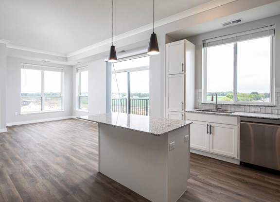 A kitchen with a large island in the middle.at The Edison at Maple Grove, Maple Grove, MN 55311
