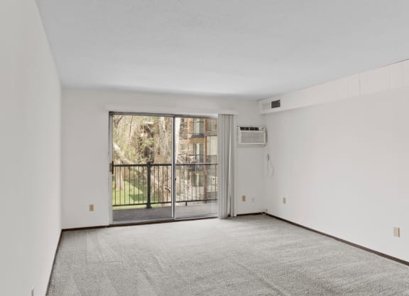 a bedroom with a large window and a balcony