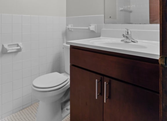 a bathroom with a toilet sink and mirror