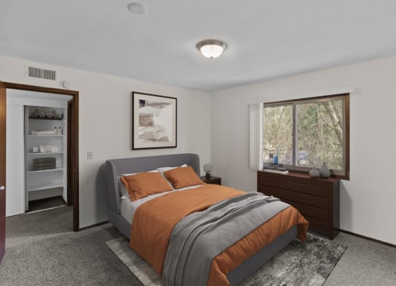 a bedroom with a bed and a dresser