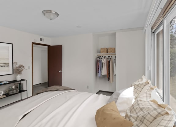 a bedroom with a large bed and a large window