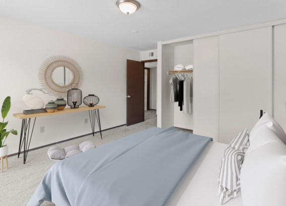 a bedroom with a bed and a wardrobe in a 555 waverly unit