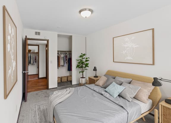a bedroom with a large bed and a closet