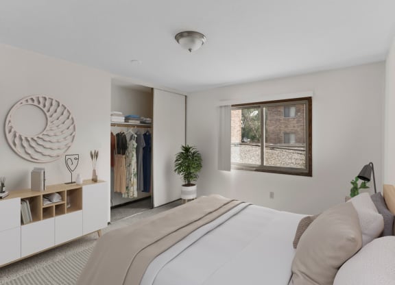 a bedroom with a large bed and a window
