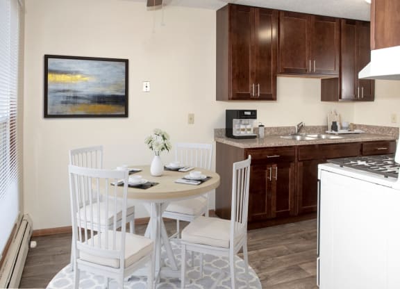 a kitchen with a table and chairs at Point of America Apartments,Minnesota, 55443