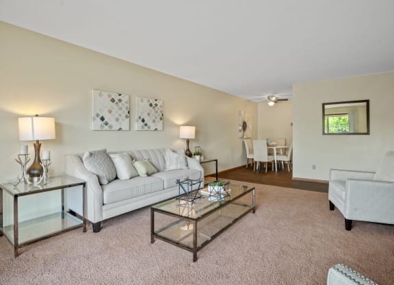 a living room with a couch and a chair at Point of America Apartments,Minnesota