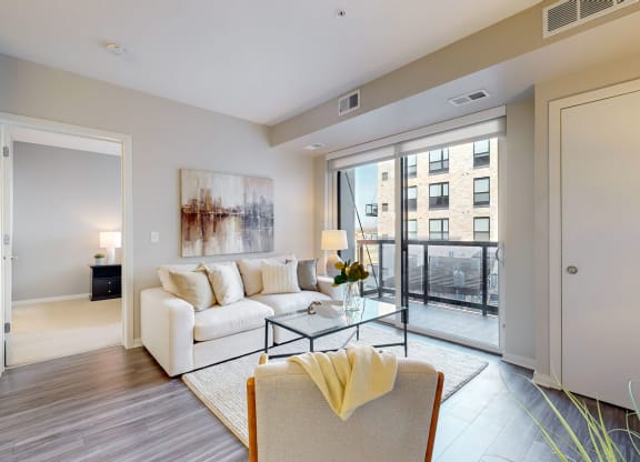 a living room with a white couch and a glass table