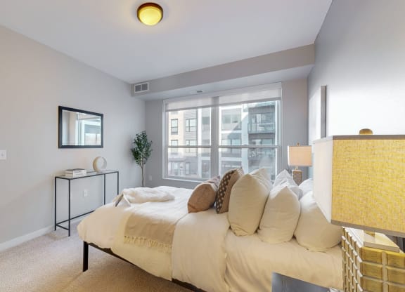 a bedroom with a large bed and a large window