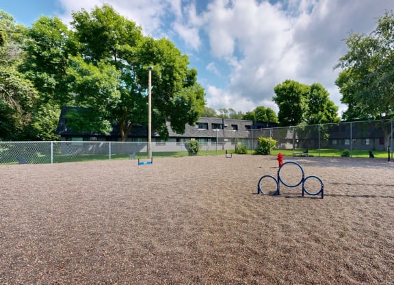 a baseball field with a bike rack in the middle of it and a bench on the side