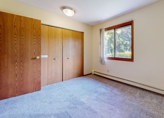 an empty room with a window and a door