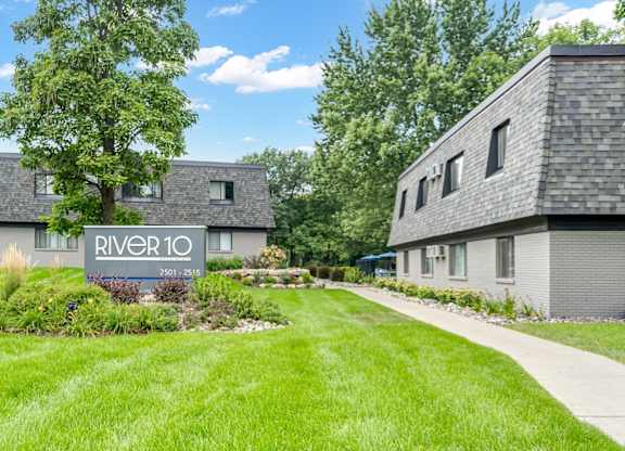 A sign that says River 10 in front of some houses.