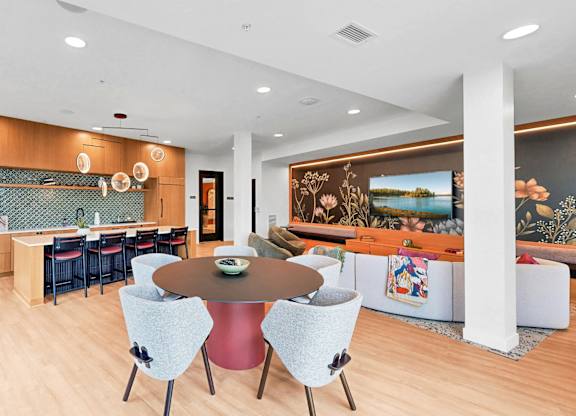 A modern dining room with a round table and chairs.