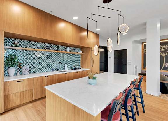 A kitchen with wooden cabinets and a white countertop.
