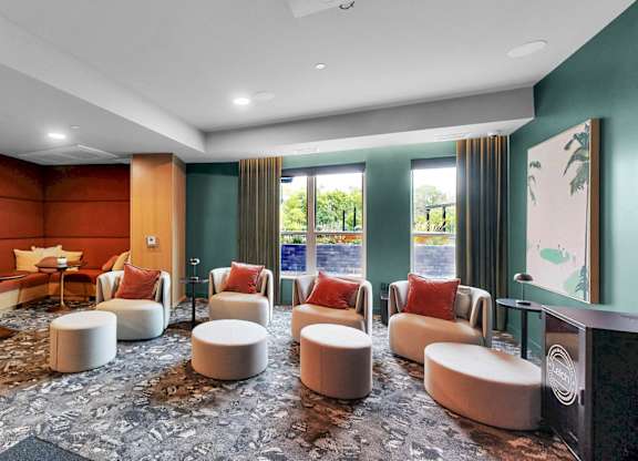 A room with a carpeted floor and a green wall.