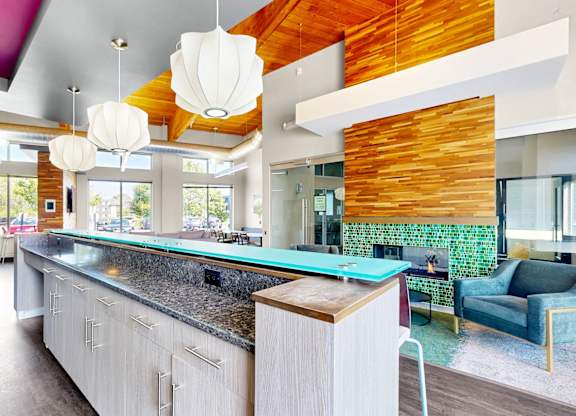 A modern kitchen with a long island and a counter top.