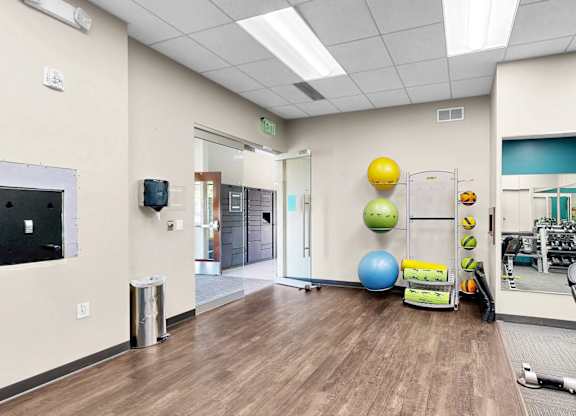 A gym room with a variety of exercise equipment.
