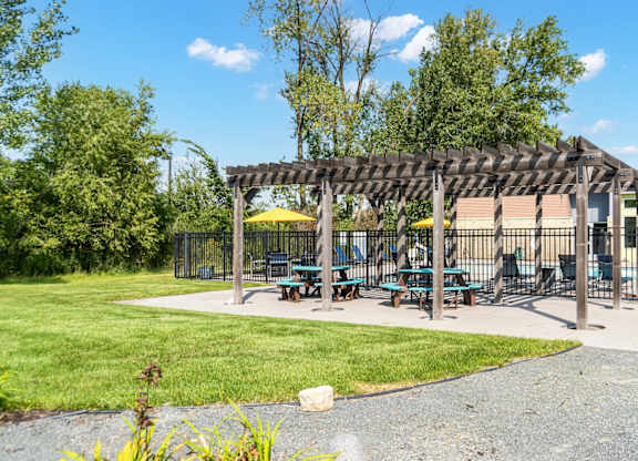 A park with a pavilion and picnic tables.