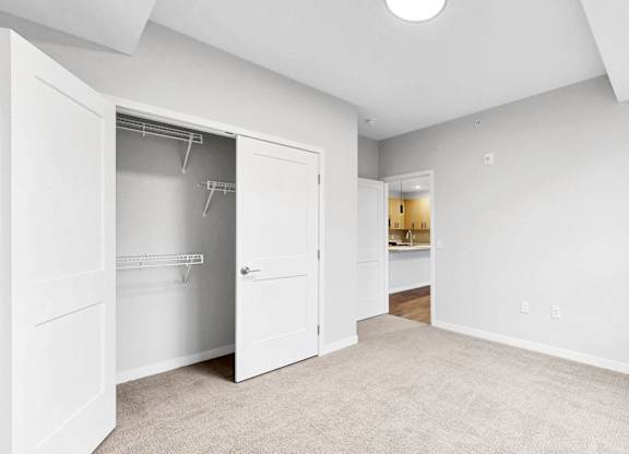 A white room with a doorway leading to another room.