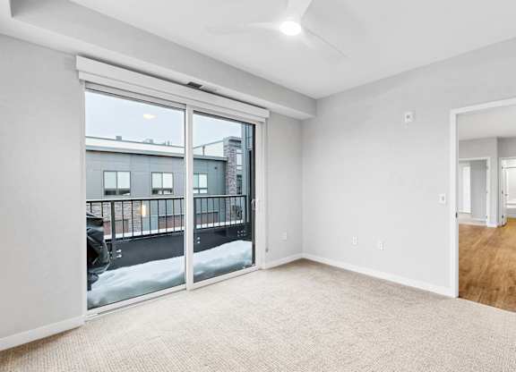 A room with a large window and sliding glass doors.