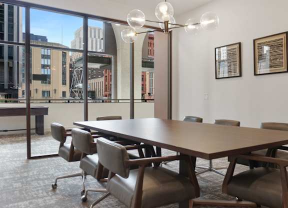 A conference room with a long table and chairs.