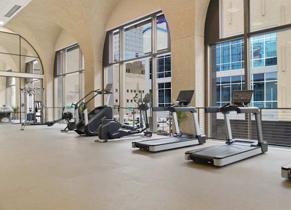 A gym with treadmills and exercise equipment.